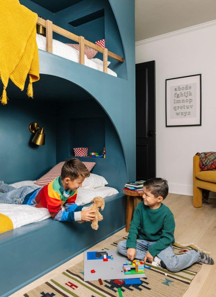 sons playing with legos in bunkbed bedroom