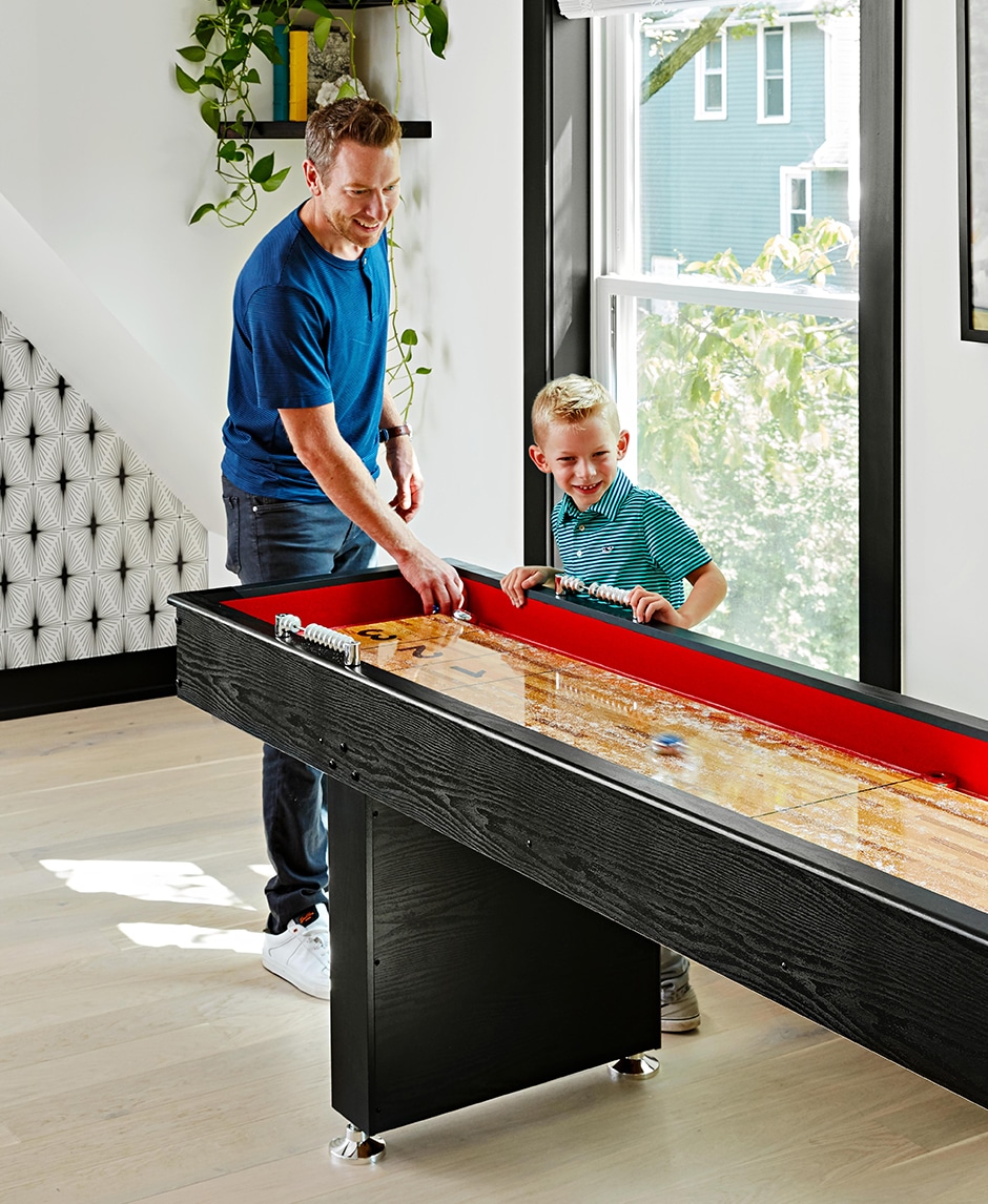 jon playing shuffleboard with son