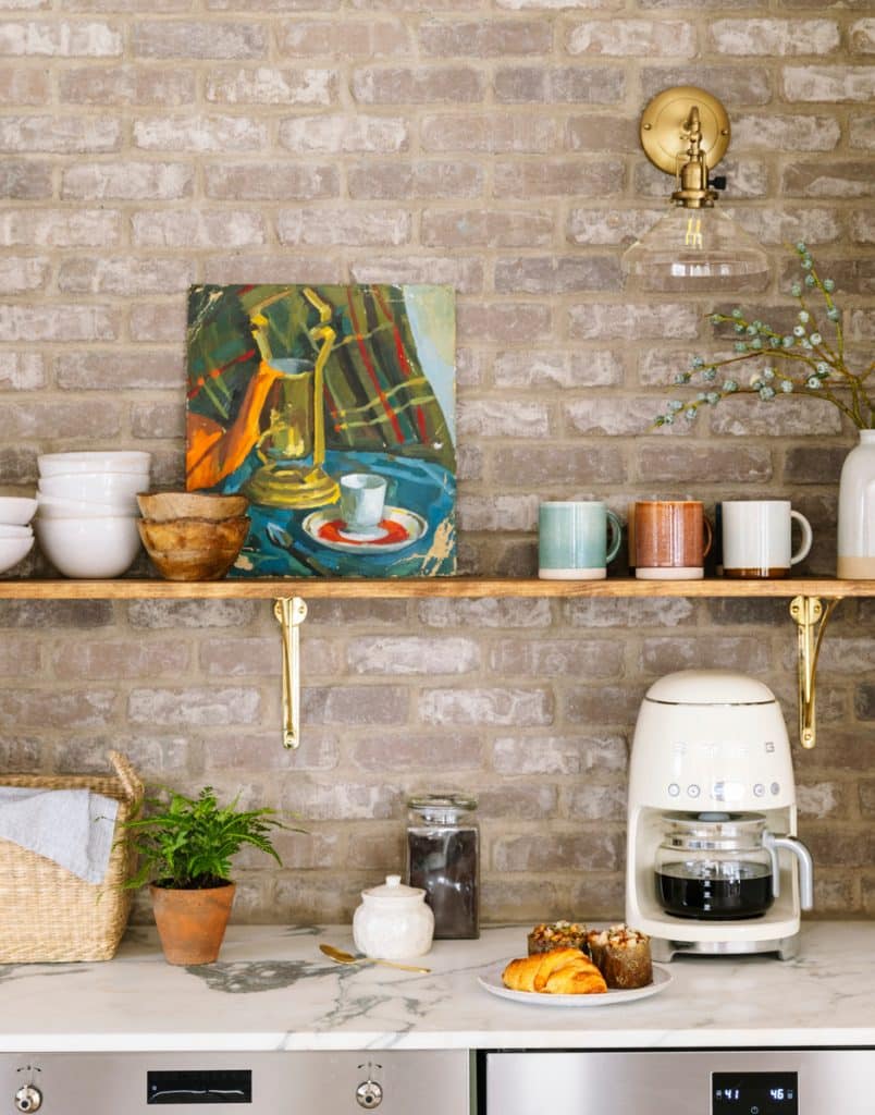kitchen with brick wall and exposed shelving