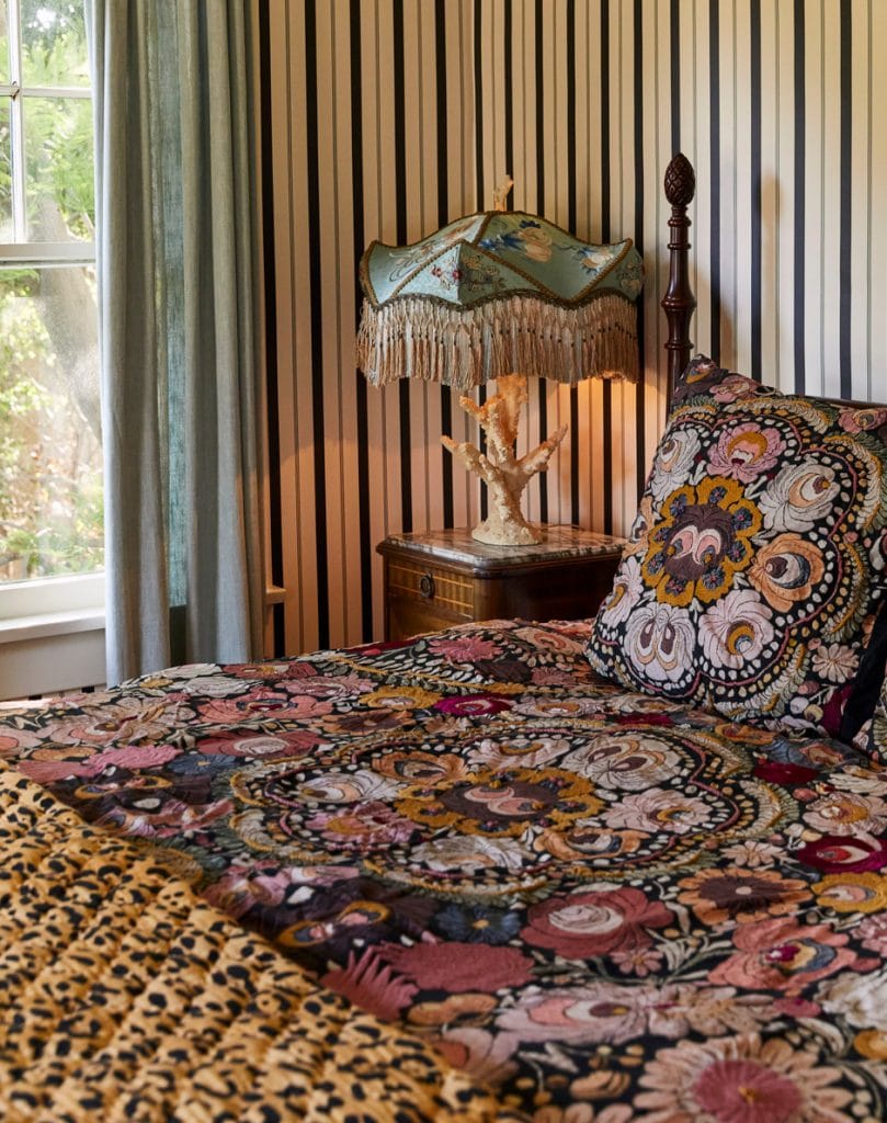 eclectic guest bedroom with vintage lamp