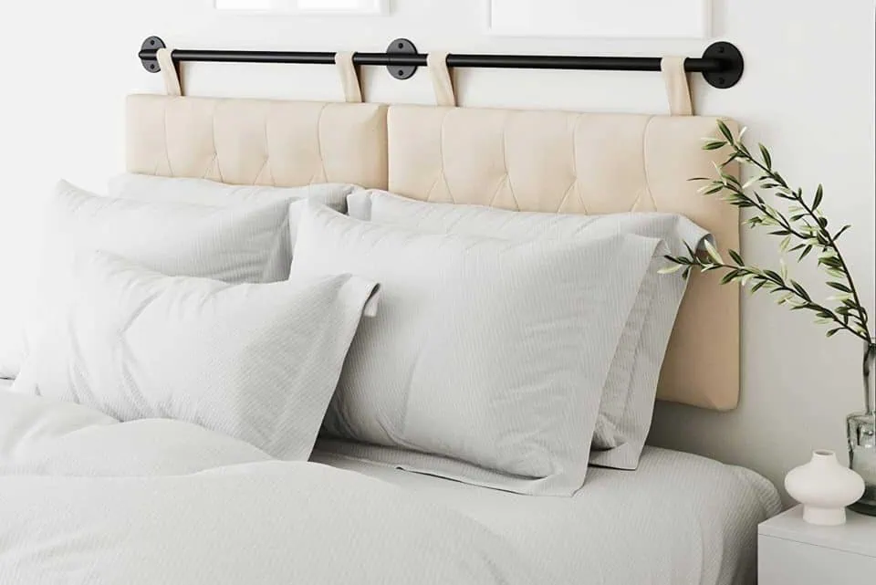Cozy bedroom with tufted headboard, crisp white bedding, and minimalist decor