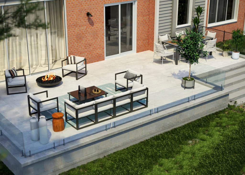 Spacious outdoor patio with modern furniture, a fire pit, a dining area, and a potted tree next to a brick house