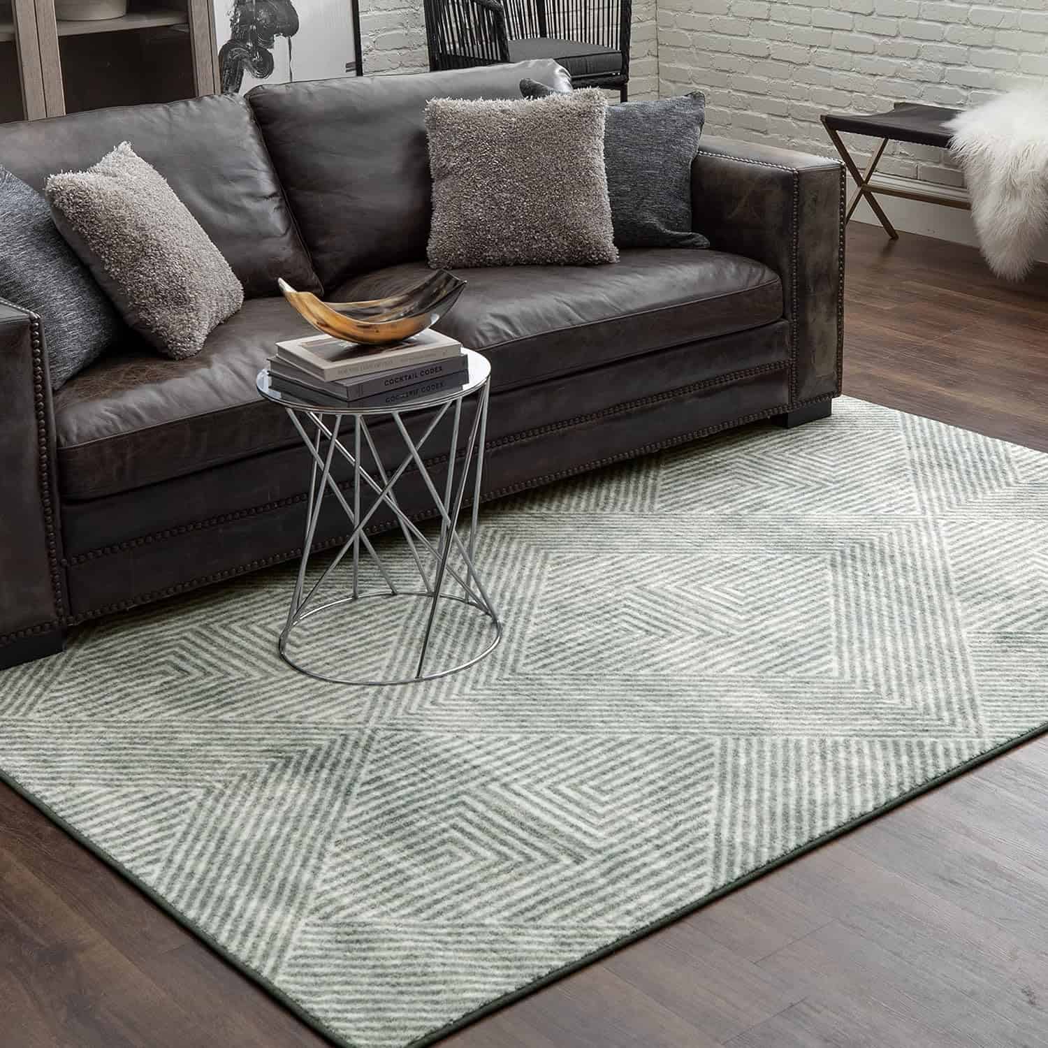 Living room with leather sofa, textured pillows, and geometric rug