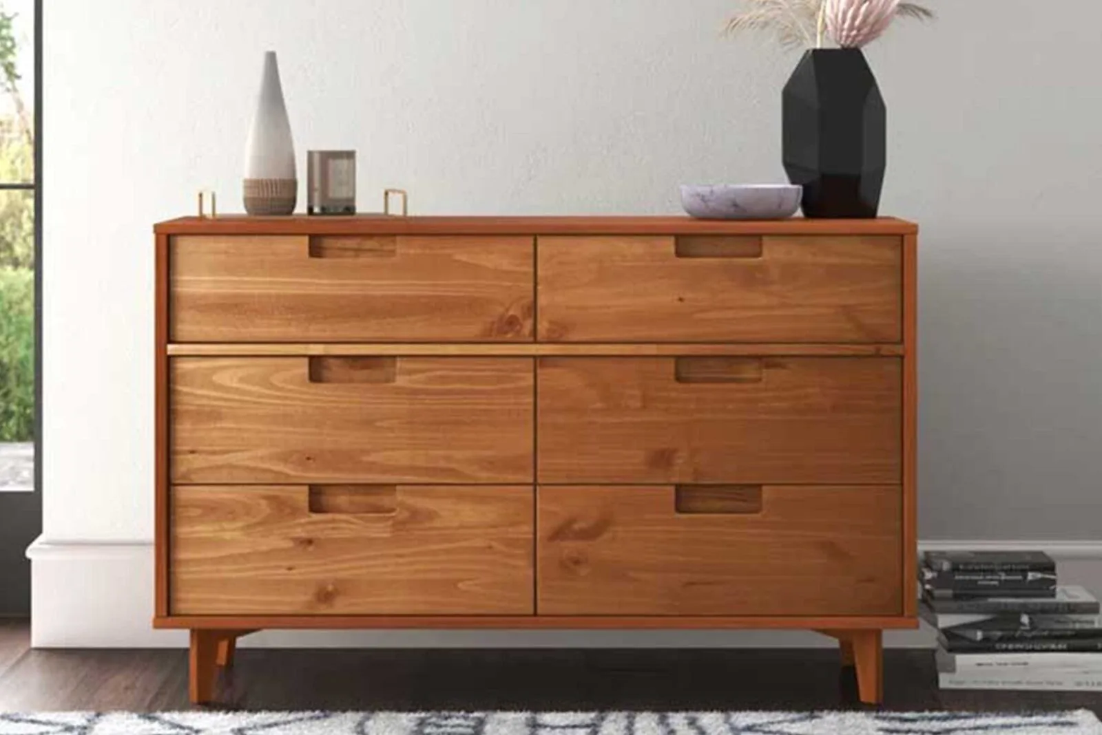 Mid-century modern wooden dresser with six drawers and minimal decor on top