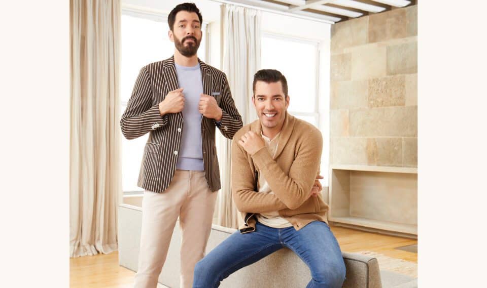 Drew and Jonathan posing in a bright room with casual and stylish outfits