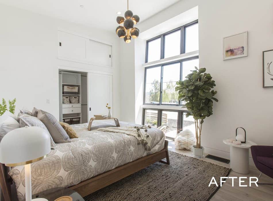 Bright modern bedroom with large windows, neutral decor, and potted plant