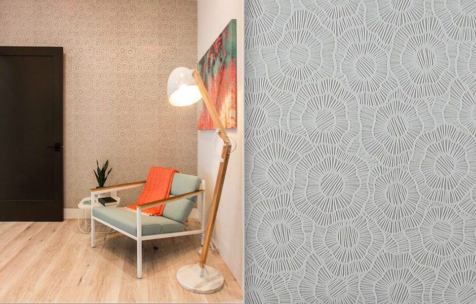Cozy reading nook with patterned accent wall, mint chair, and floor lamp