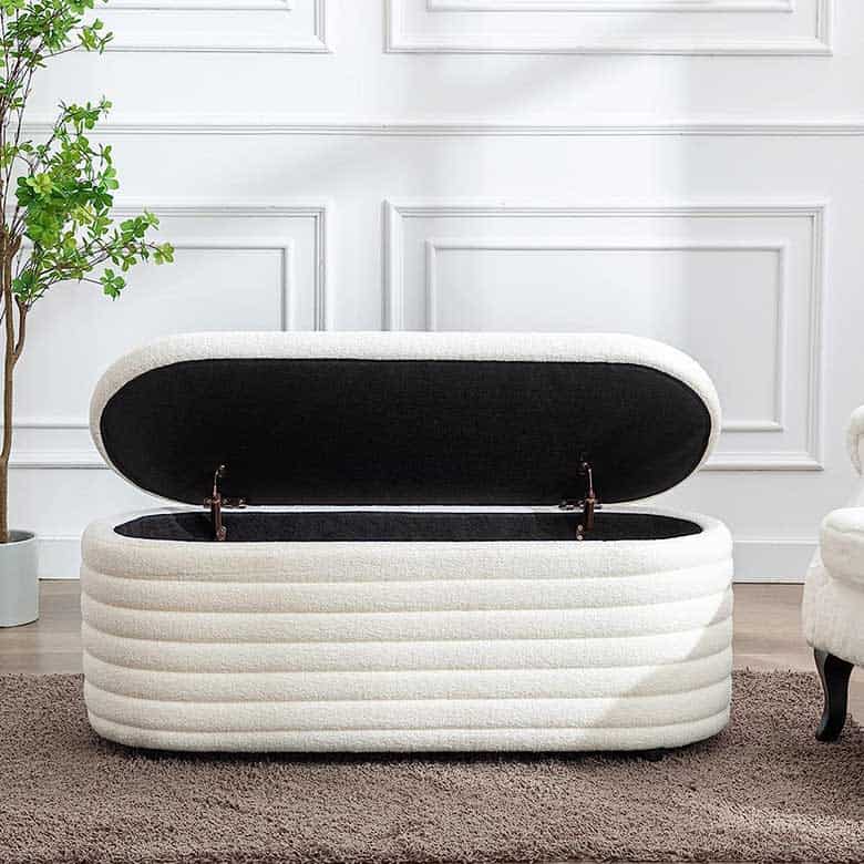 White upholstered storage bench with an open lid in an elegant living space