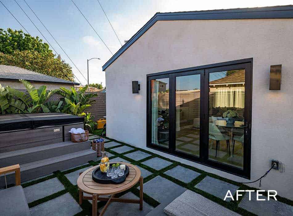 Modern backyard with patio seating, sliding glass doors, and jacuzzi area