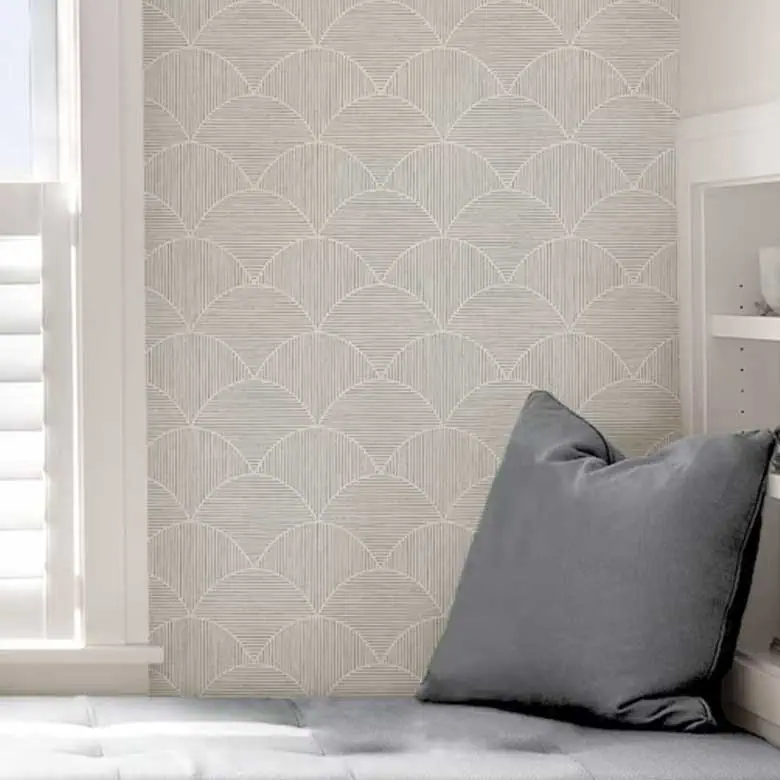 Cozy corner with patterned wallpaper, gray cushion, and white shelving