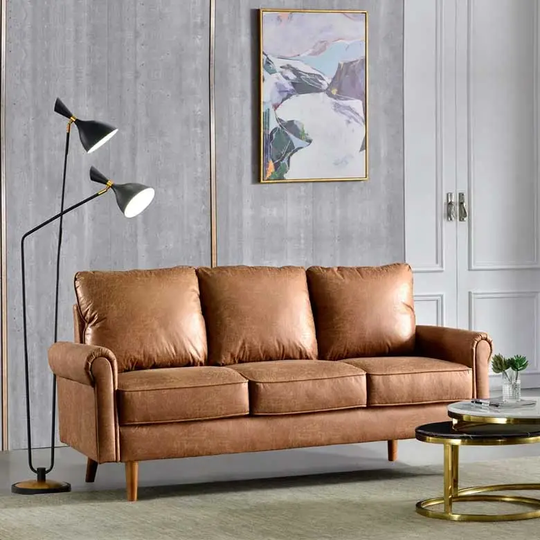 Living room with a brown leather sofa, modern floor lamp, and gold-accented coffee table