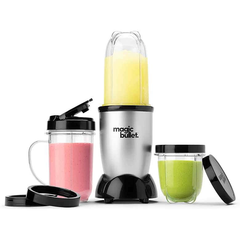 Magic Bullet blender with a pink smoothie cup, a green smoothie container, and a blending jar