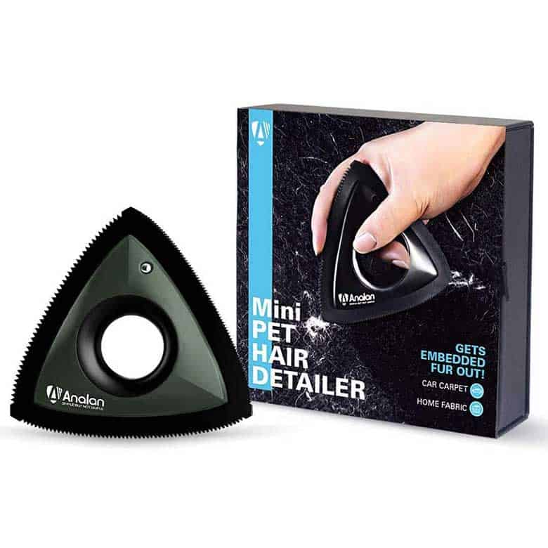 A triangular pet hair remover for carpets and fabrics, shown with its packaging