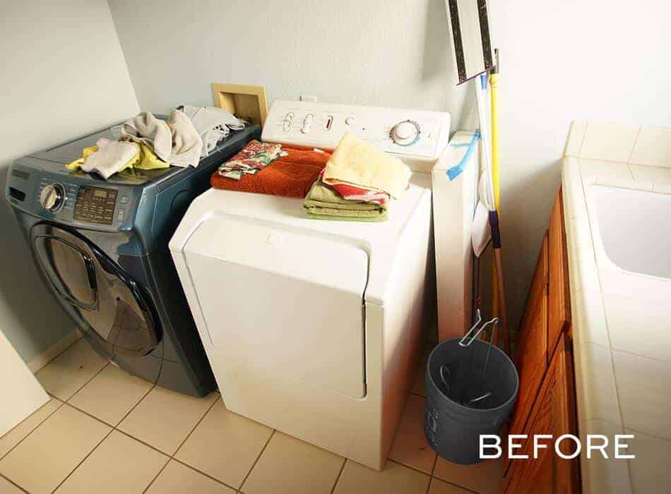 Cluttered laundry room with washer, dryer, and cleaning supplies