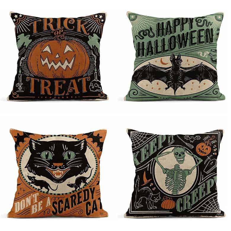 Set of four Halloween-themed throw pillows with vintage-style designs and spooky phrases