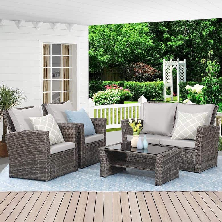 Covered patio with wicker outdoor furniture, a glass-top coffee table, and a garden view