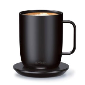 Black Ember temperature-controlled smart mug with latte on a matching charging coaster