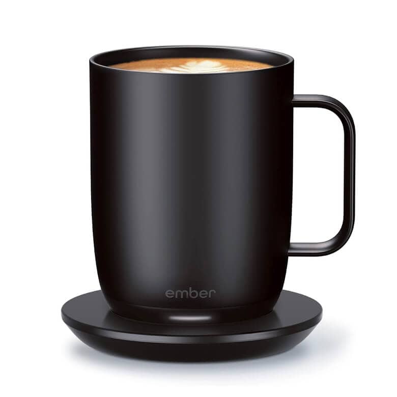 Black Ember temperature-controlled smart mug with latte on a matching charging coaster