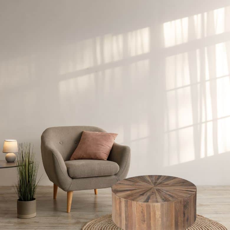 Minimalist space with taupe chair and round wood table