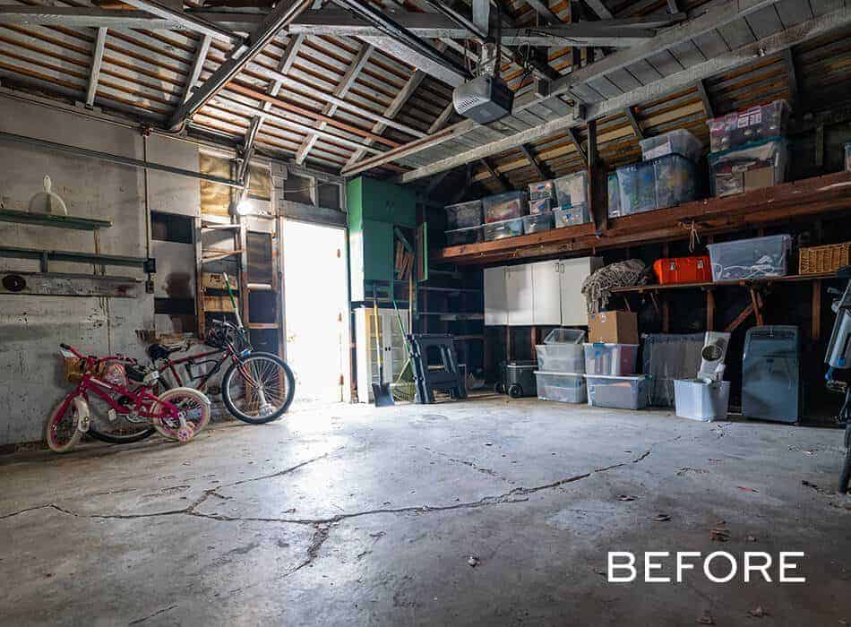 Cluttered garage with exposed beams, storage bins, and bicycles