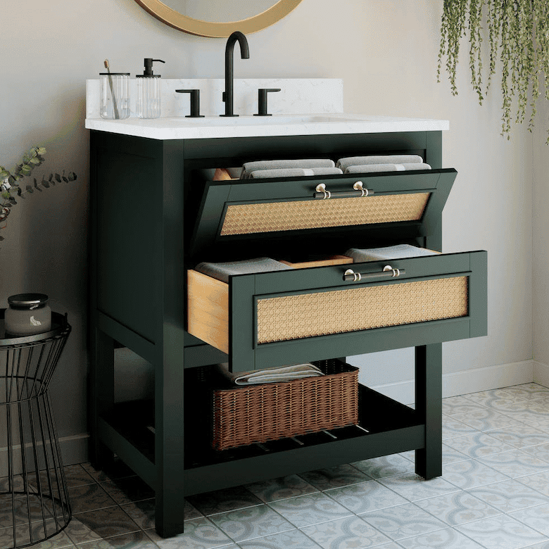 Green bathroom vanity with marble countertop and woven drawers, black faucet, and round mirror