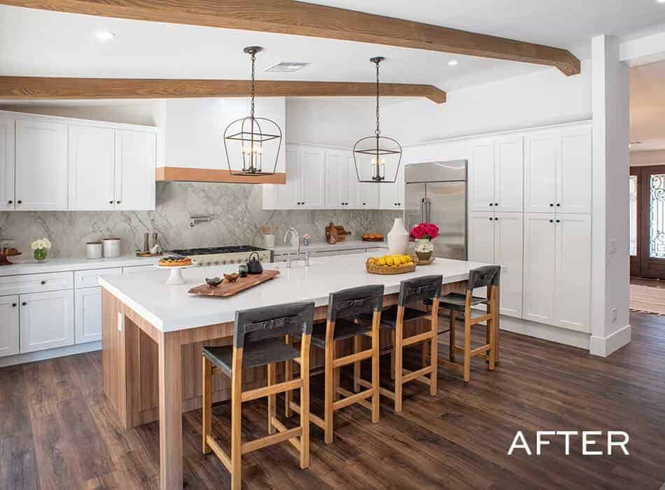 Farmhouse kitchen with a large island, wood beams, and pendant lighting