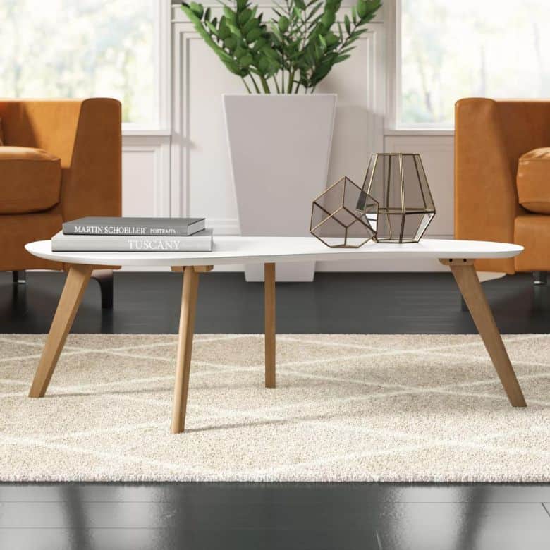 Mid-century modern coffee table with white top and wood legs