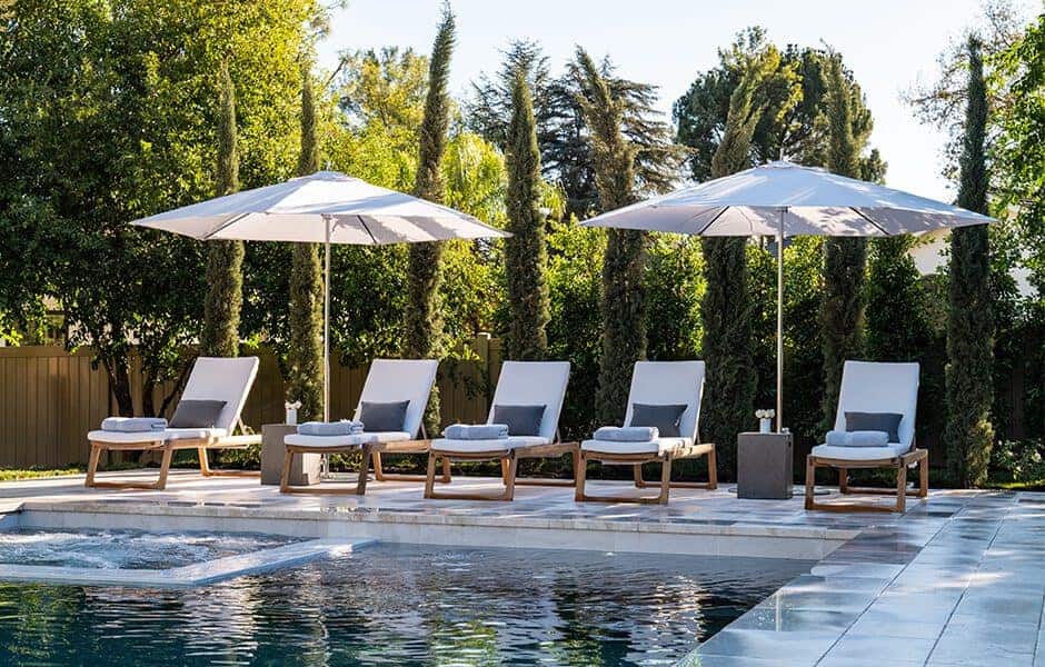 Outdoor pool area with lounge chairs and umbrellas