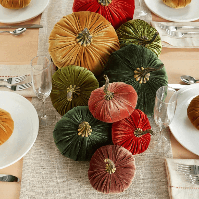 Velvet pumpkins in green, red, and gold as a table centerpiece