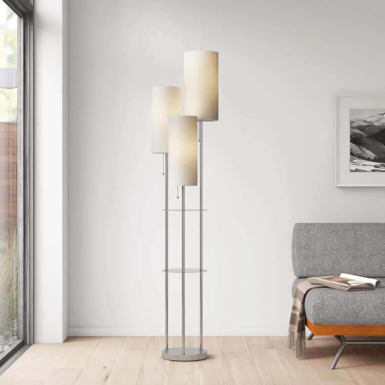 Modern floor lamp with three cylindrical shades and built-in glass shelves