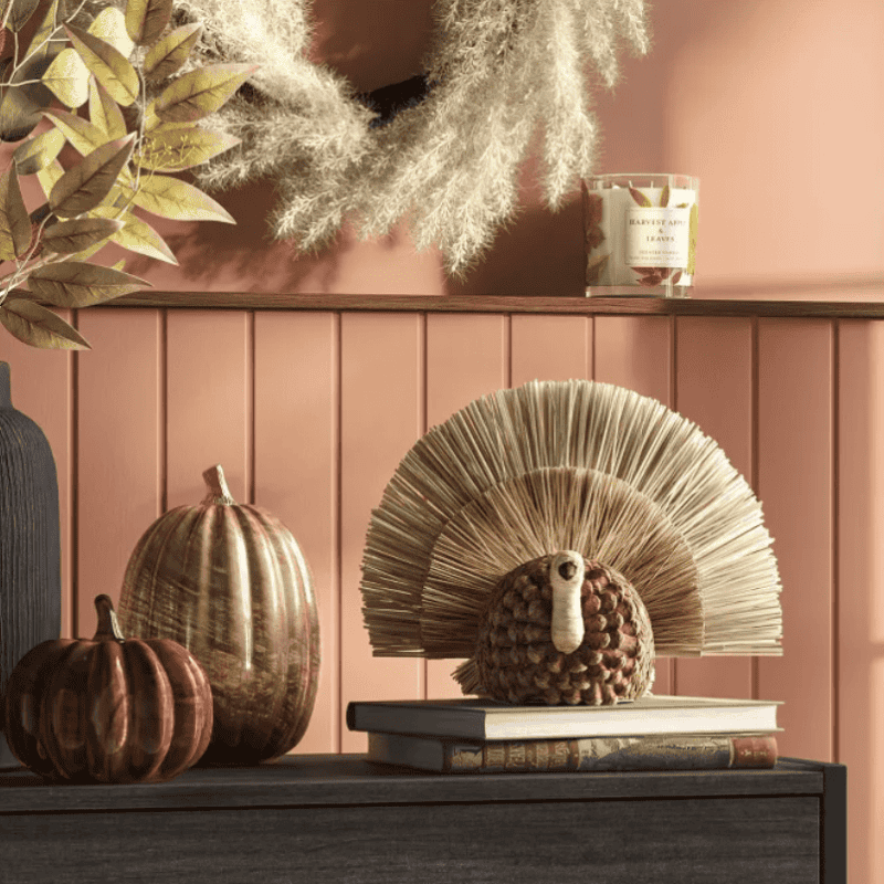 Thanksgiving shelf decor with straw turkey pumpkins and fall candle