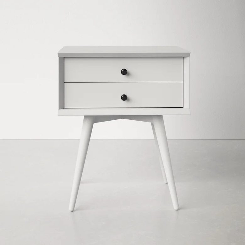 Minimalist white nightstand with two drawers and black knobs