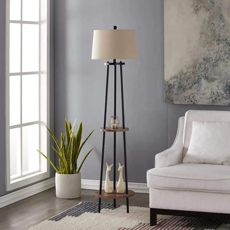 Modern living room corner with a floor lamp featuring built-in shelves, a snake plant, and a white armchair
