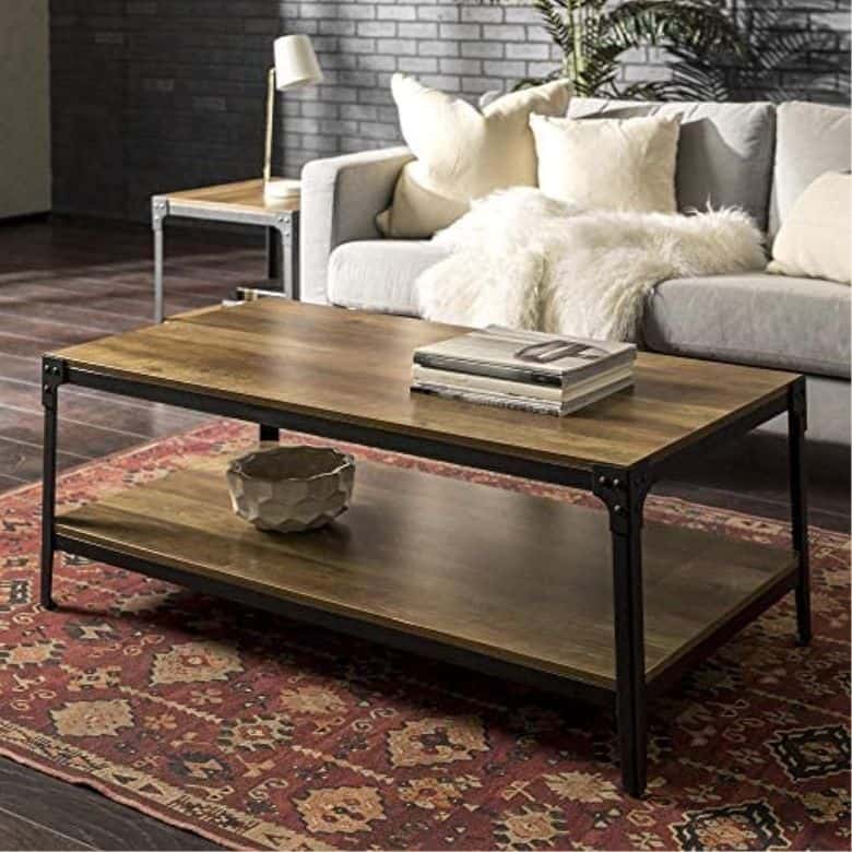 Industrial-style living room with wood and metal coffee table, gray sofa, and red patterned rug