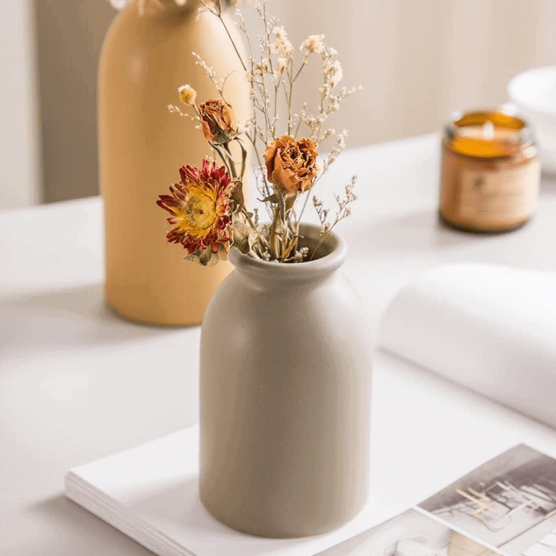 Minimalist beige vase with dried flowers, perfect for a cozy and warm decor accent