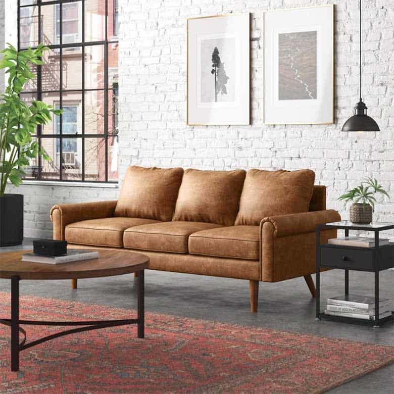 Mid-century modern style sofa in a living room with brick walls and artwork