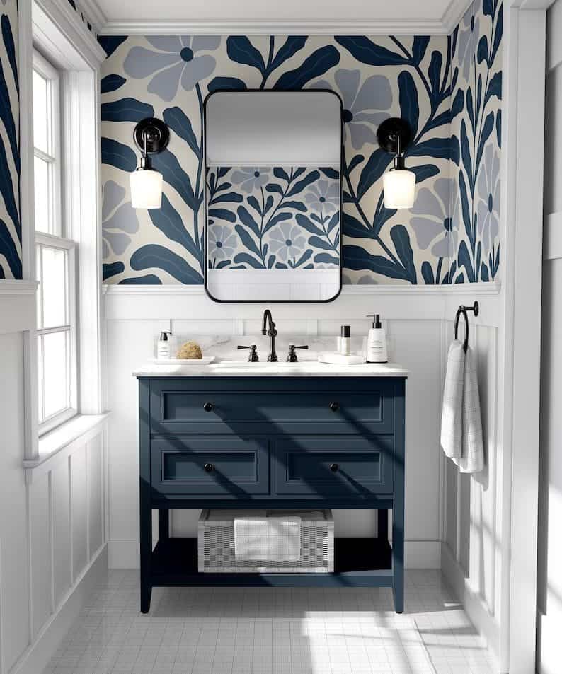 Stylish bathroom with blue floral wallpaper, navy vanity, and black accents