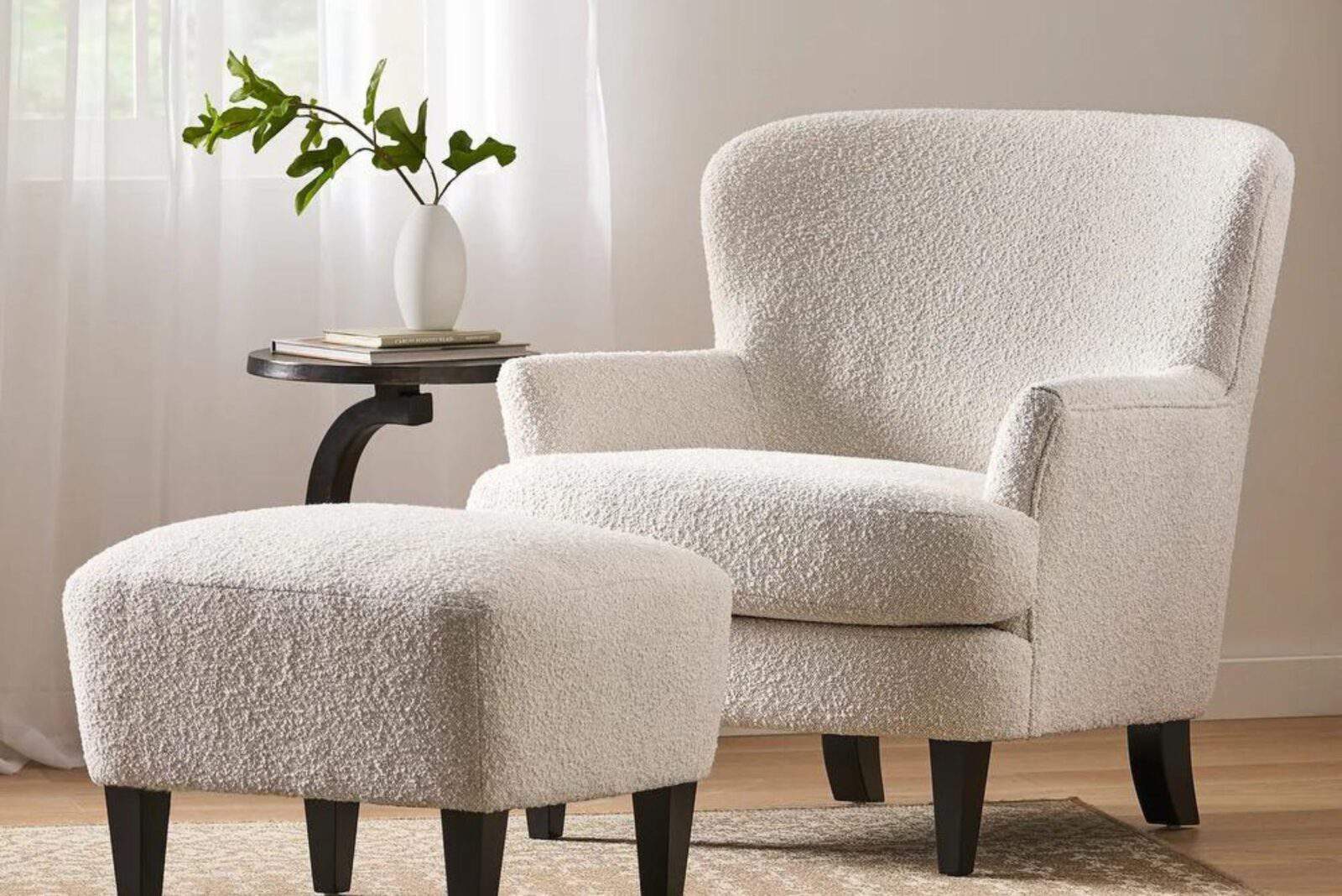 White armchair with ottoman and side table