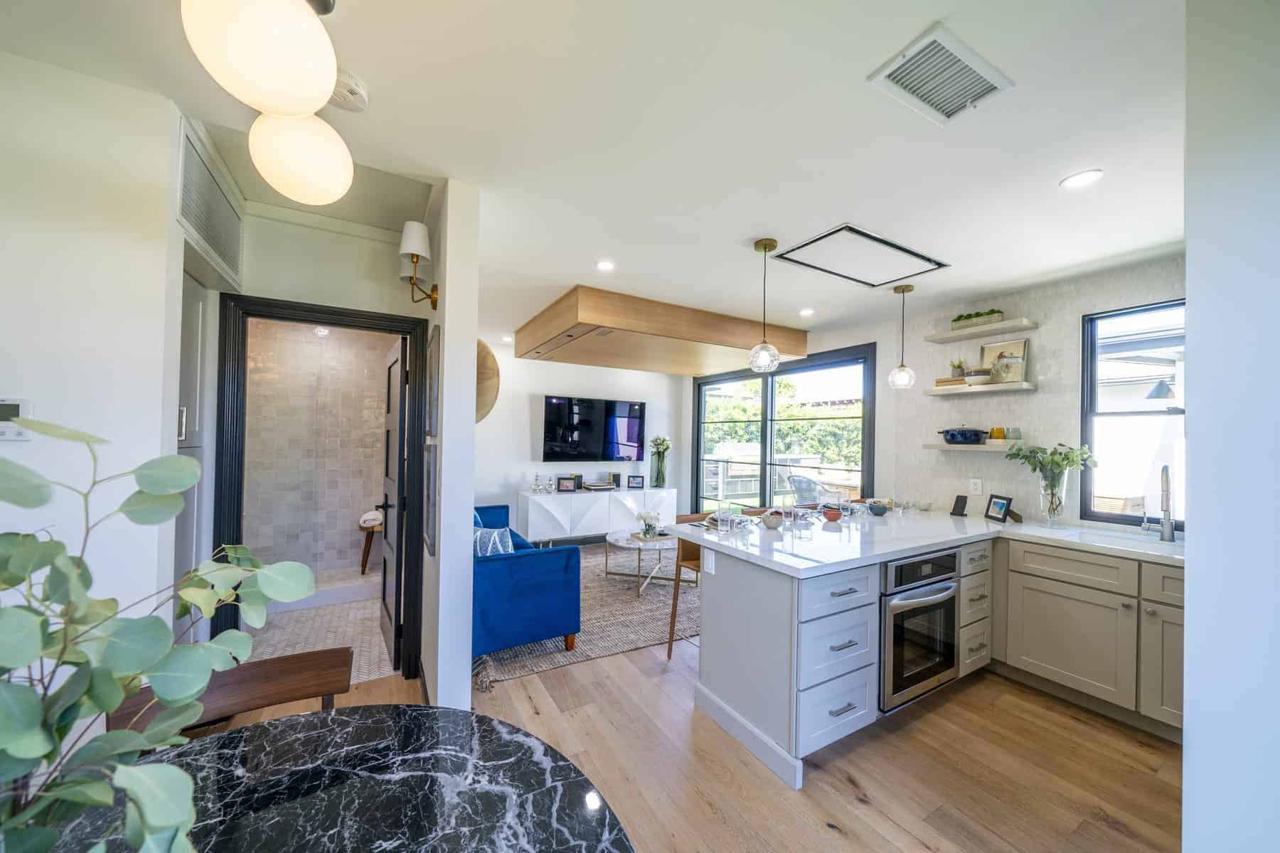 Open-concept kitchen and living area with modern finishes and natural light