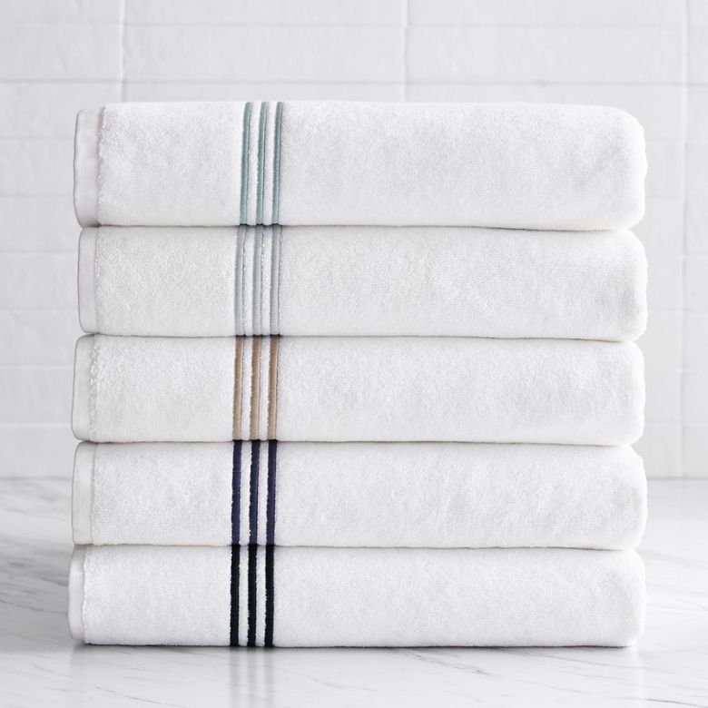 stack of white embroidered bath towels