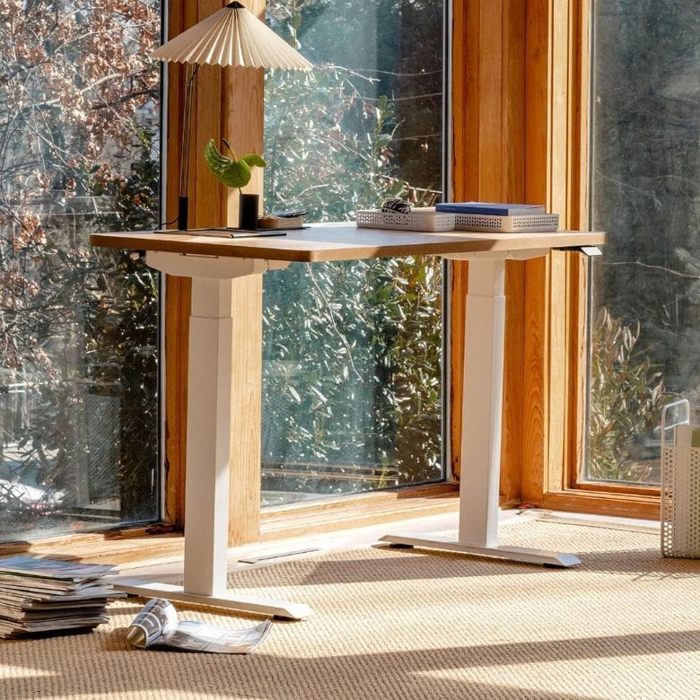 adjustable standing desk with white legs and black top
