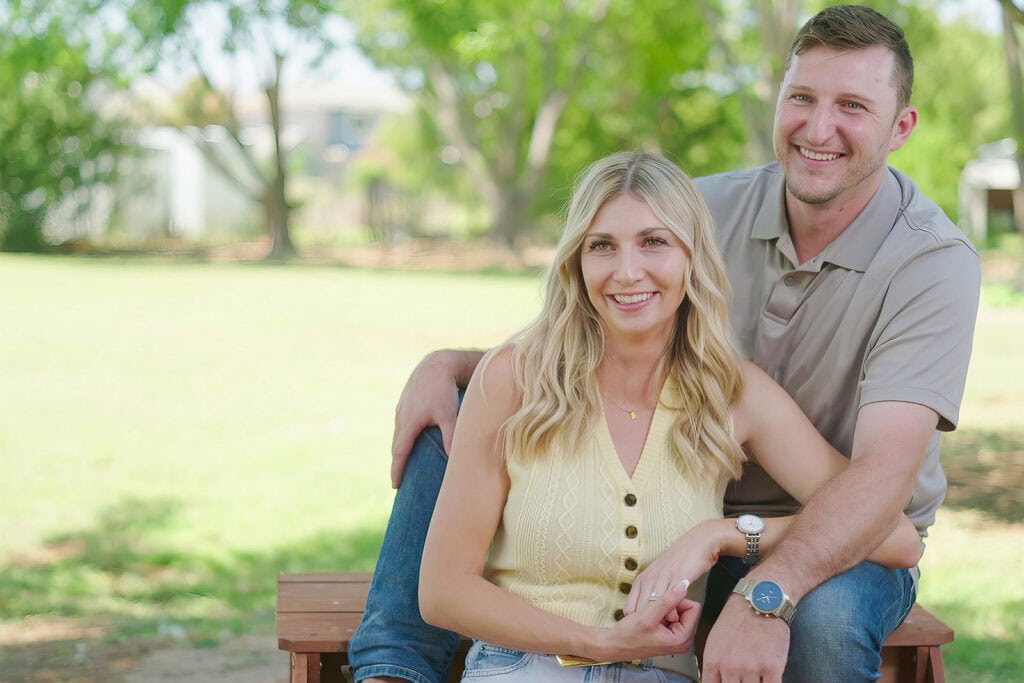 sydney and karsten smiling on a bench from chasing the west season 1 episode 4