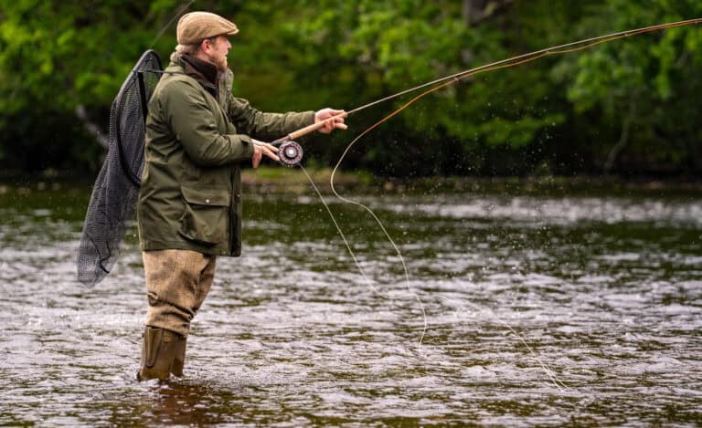 Trout fishing at Erchless Castle Estate, stunning Scottish river landscape, outdoor leisure activity, angler in nature.