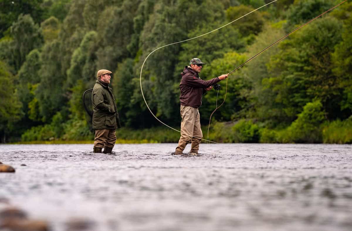 Riverside fishing at Erchless Castle Estate, Highland Scotland, perfect for outdoor fishing adventures.