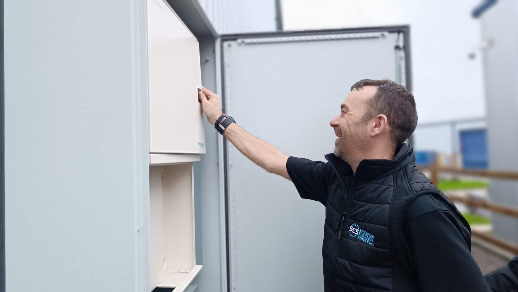 Technician conducting site survey for EV charging point installation.