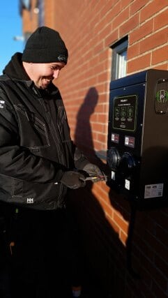 EV charger being installed outside a commercial building for Liquid Dynamics International Ltd.