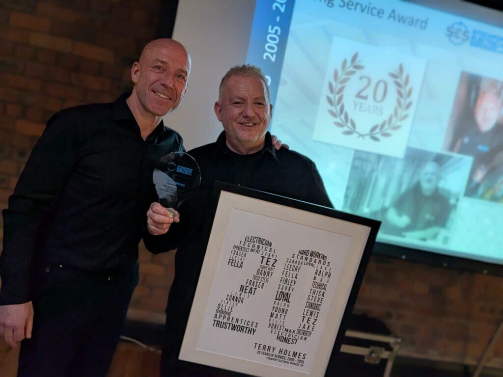 Electrical services team celebrating 15 years of excellence in Stockport.