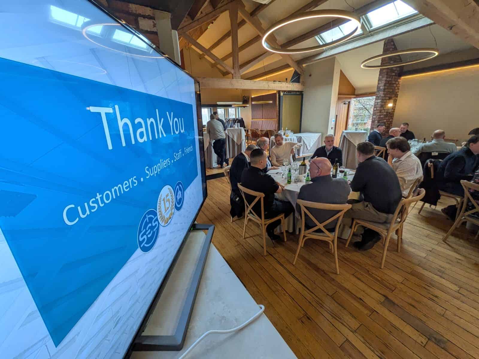 Modern conference room with a large screen displaying "Thank You"