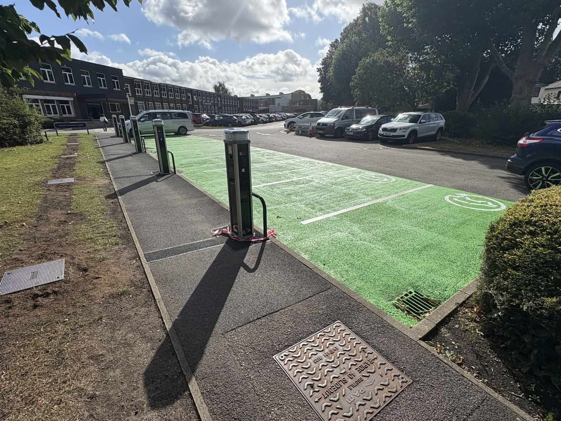 EV charging point with green parking space for electric cars.