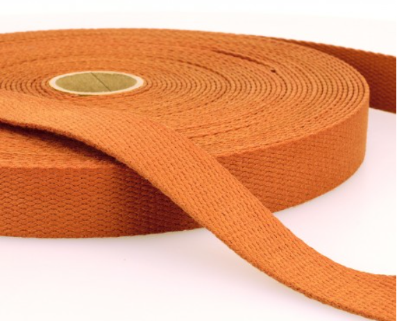 Bright orange woven elastic band, ideal for garment and craft projects, available at Fabric & Finery in the UK. Durable and versatile for fashion sewing, sportswear, and DIY textiles.